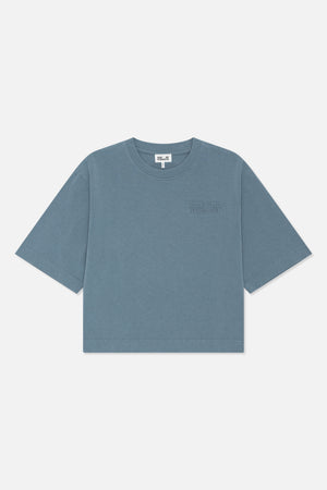 Front view of a blue-gray short-sleeved crew-neck T-shirt with a subtle tonal Baum und Pferdgarten chest logo.
